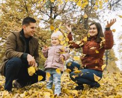 young family playing with leaves autumn forest 500x400